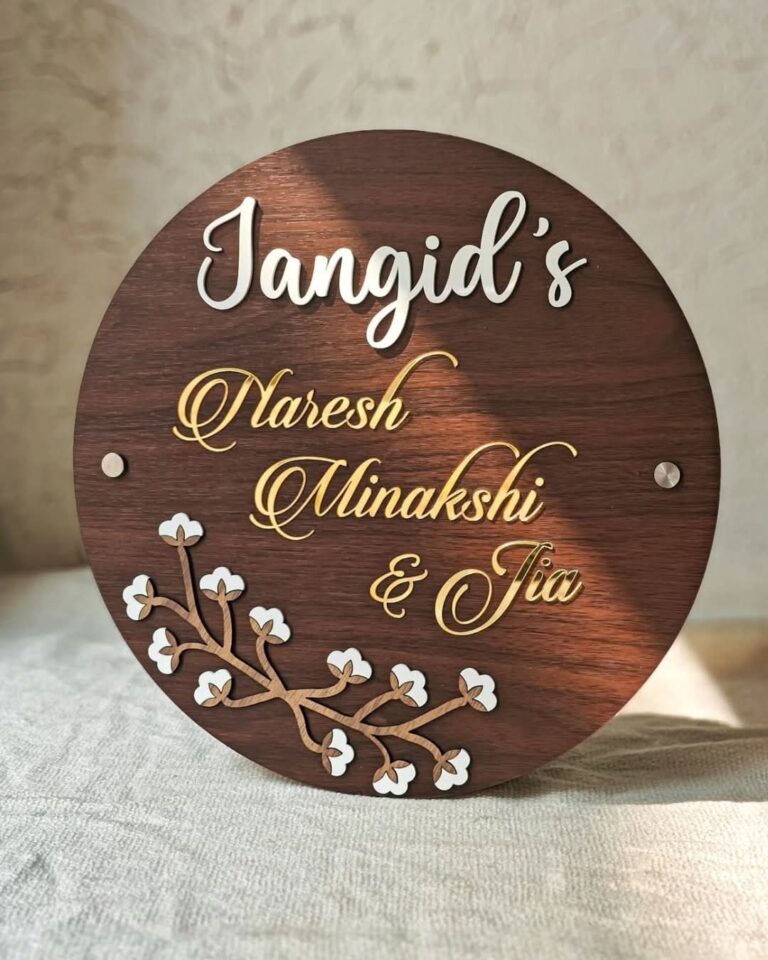 Round wooden name plate with gold and white letters