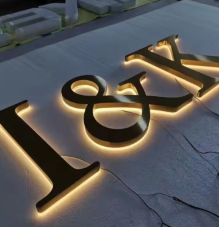 Stainless steel LED letter sign with warm halo backlighting