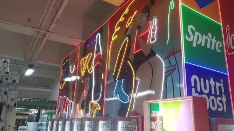 Side view of a retail neon feature wall with brand panels