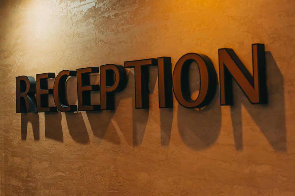 Raised reception sign letters on a warm textured wall